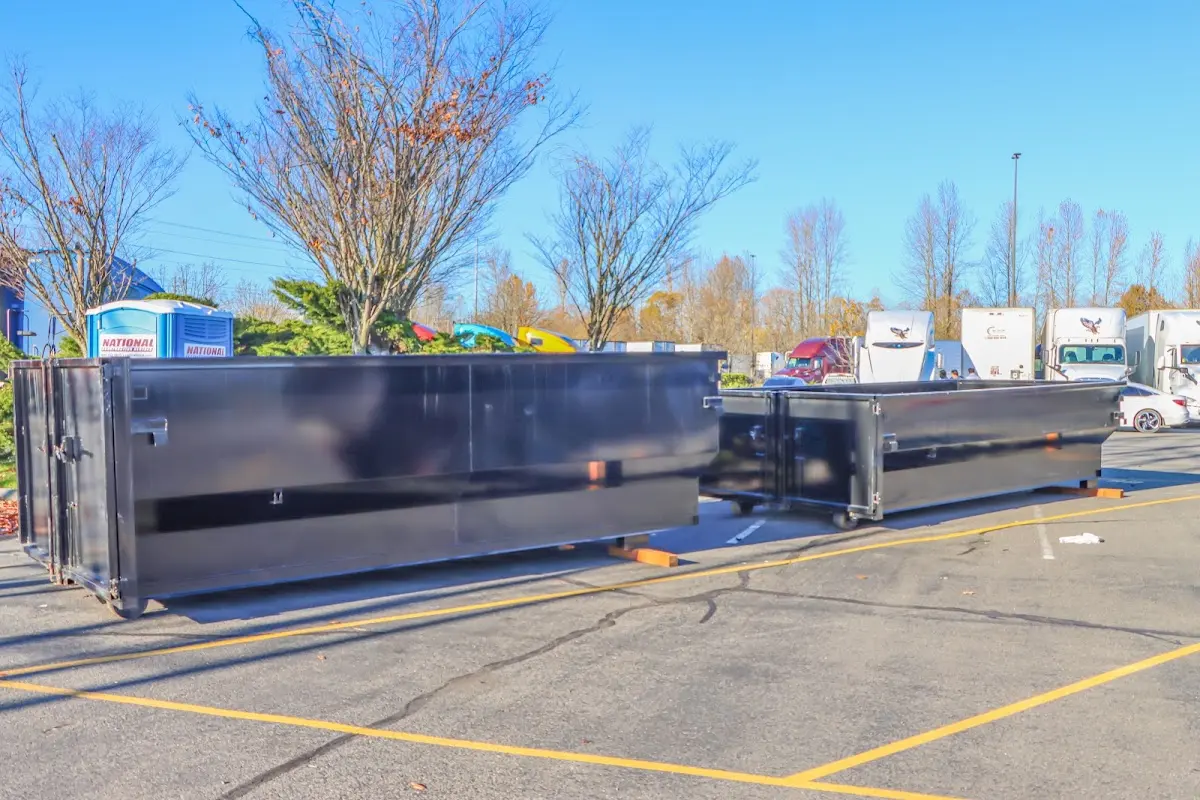 Professional dumpster rental service with roll-off container on residential driveway in North Smithfield